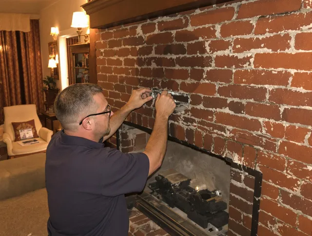 Tallmadge Chimney Sweep expert fixing a fireplace in Tallmadge, OH